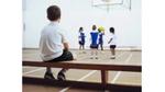 Boy sitting on a bench watching sport