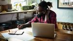 Man with beard working at laptop. Unilever Flex Experience matches people with projects that offer the chance to upskill.