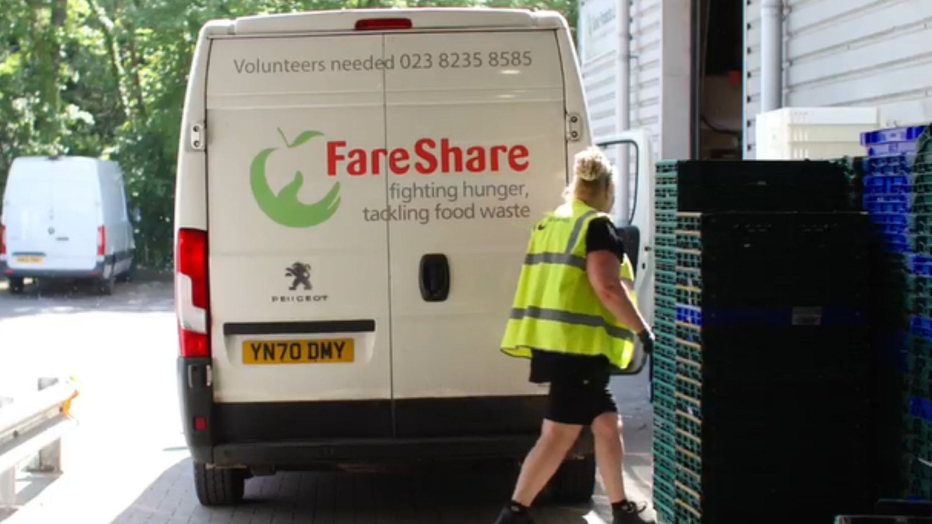 A worker walks past a FareShare van.