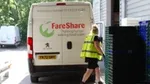 A worker walks past a FareShare van.