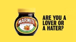 A jar of marmite against a yellow background, with text to the side saying 'are you a lover or a hater?