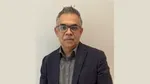 Portrait of Vivek Sirohi, a man with grey hair and moustache wearing glasses.
