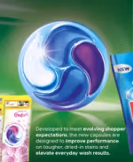 Close-up of Persil four-chamber laundry capsule with Comfort fragrance pack, emphasizing improved stain performance.