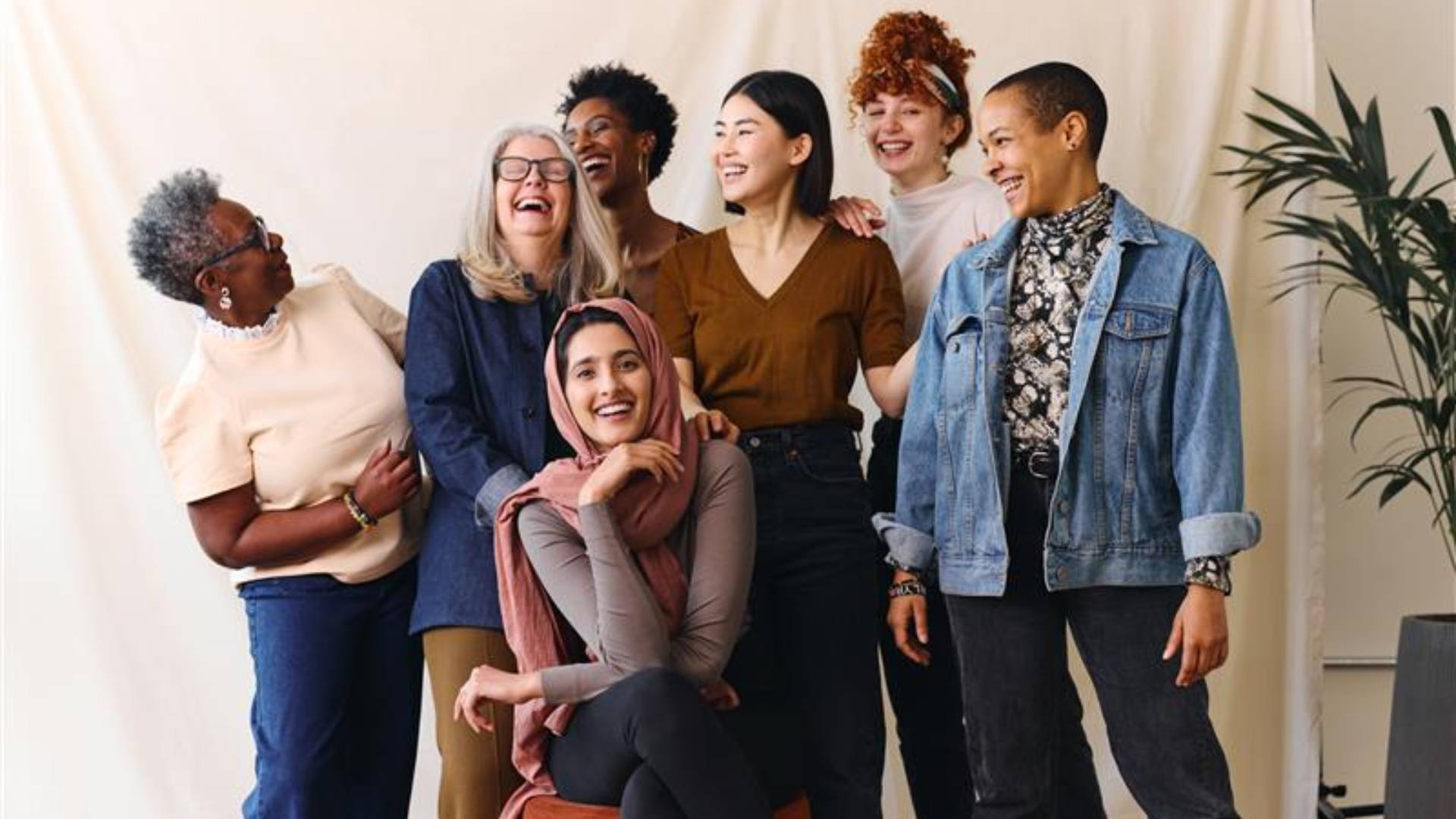 Group of diverse women smiling together indoors.