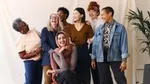 Group of diverse women smiling together indoors.