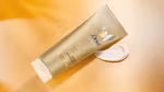 Dove Summer Revived lotion from Dove’s gradual tan range to give skin a summer glow. Product shown with amber background