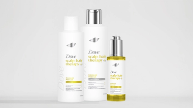 Dove Scalp + Hair Therapy Damage Rescue shampoo, conditioner and serum bottles.