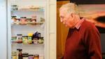 man looking into fridge