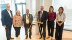 Group of attendees standing beside a commemorative plaque marking the opening of Sunlight House, Unilever's new UK and Ireland headquarters in Kingston upon Thames.