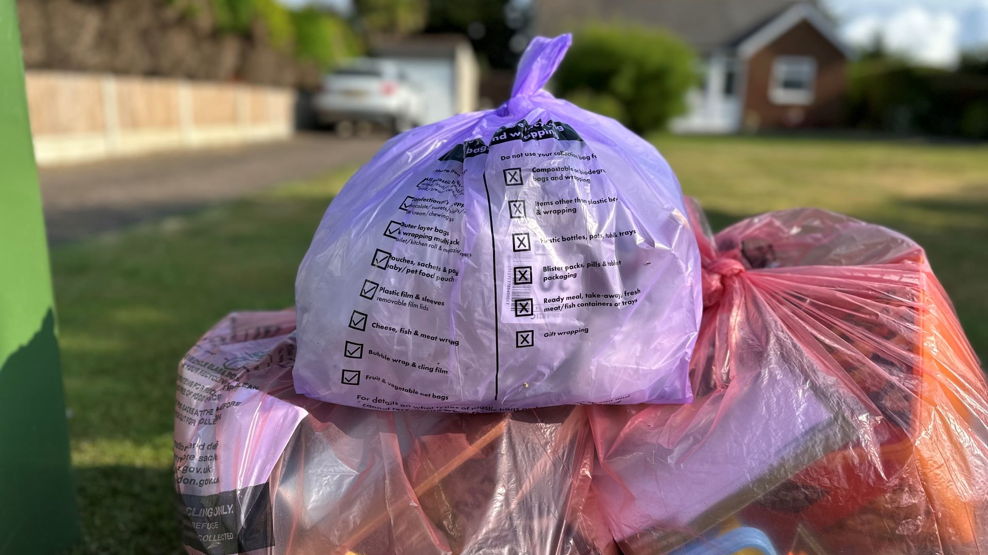 Recycling bags ready for collection at the front of a house