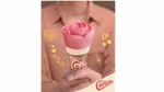 Woman holding the distinctive pink rose-shaped Cornetto Rose cone
