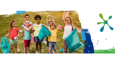 A group of happy children recycling.
