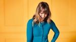 Woman laughing on a yellow background