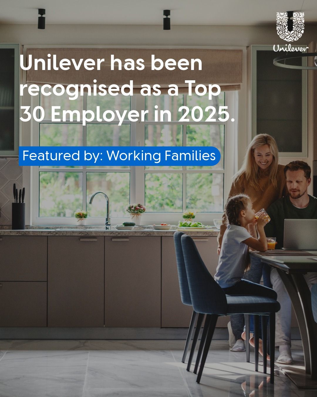 Two people holding an Grocer Gold award.