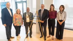 Group of attendees standing beside a commemorative plaque marking the opening of Sunlight House, Unilever's new UK and Ireland headquarters in Kingston upon Thames.