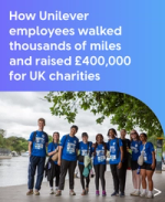 Group of Unilever employees in blue charity walk T-shirts smiling together beside a riverside path